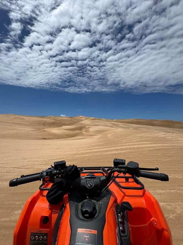 Rider POV from orange quad overlooking dunes after argan forest near Essaouira